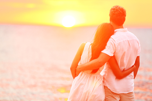 a loving couple walking on the beach